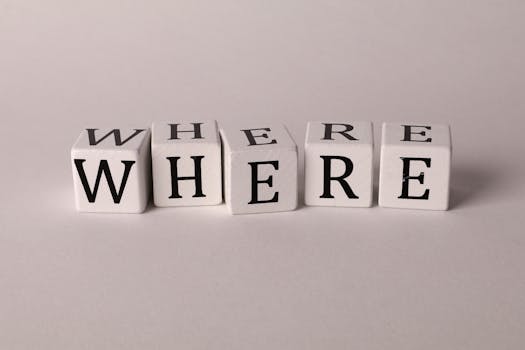 Close-up of white blocks with letters spelling 'WHERE' against a plain background.